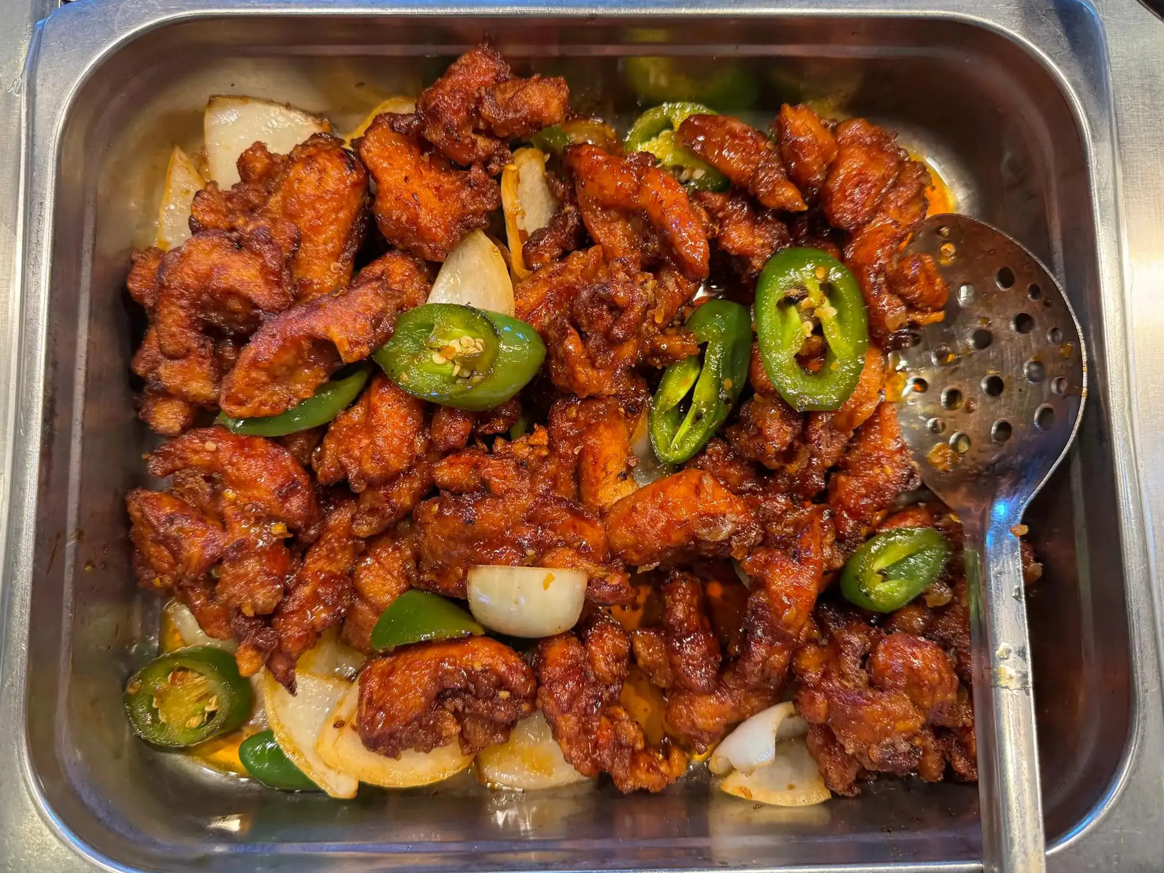 Chicken wings cooked with spicy sauce and jalapeño at Aloha Wok & Grill BBQ, a Asian Fusion Restaurant in Fullerton